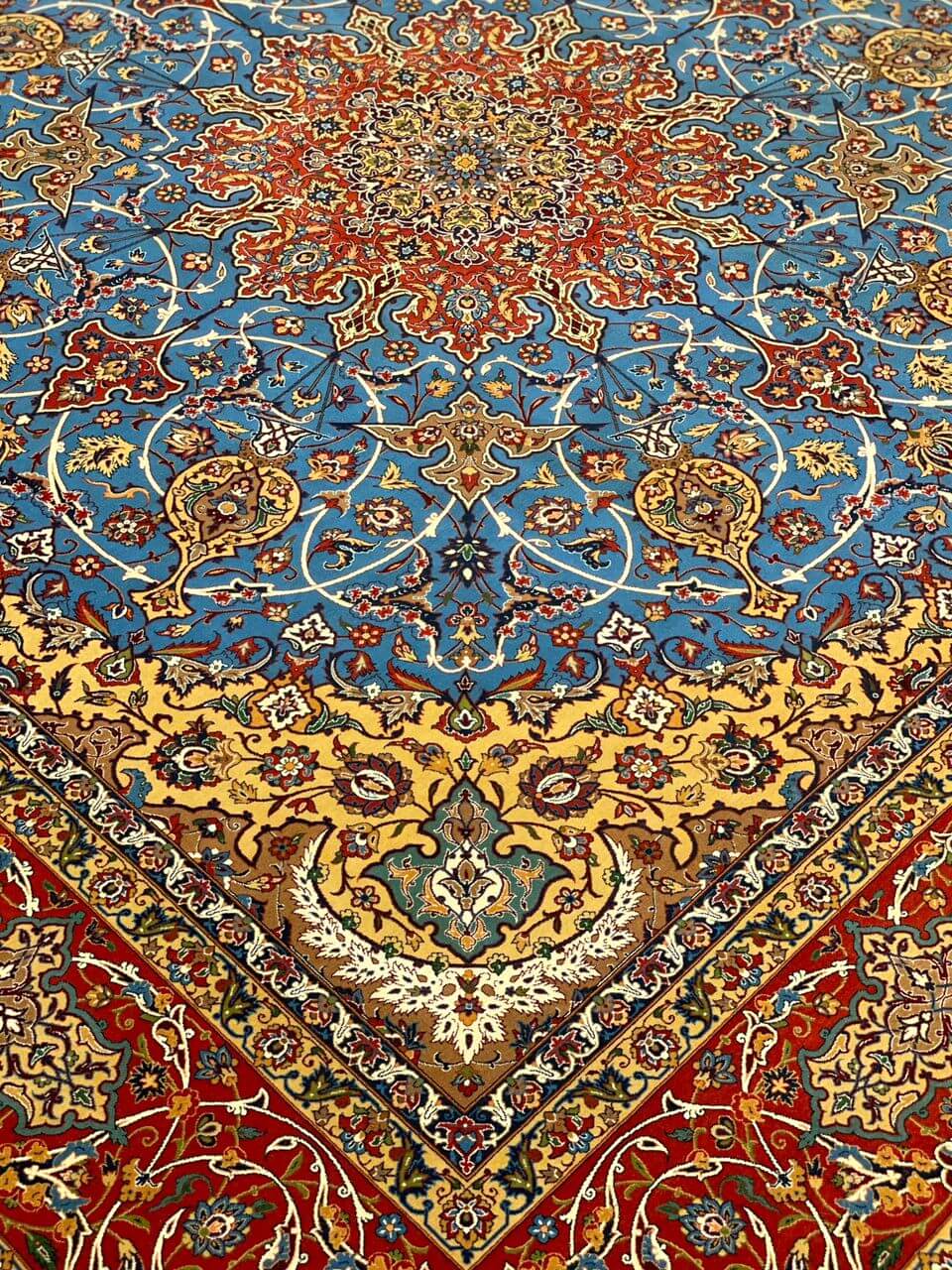 "Red and blue Persian rug from Isfahan, hand-knotted with wool and silk blend."